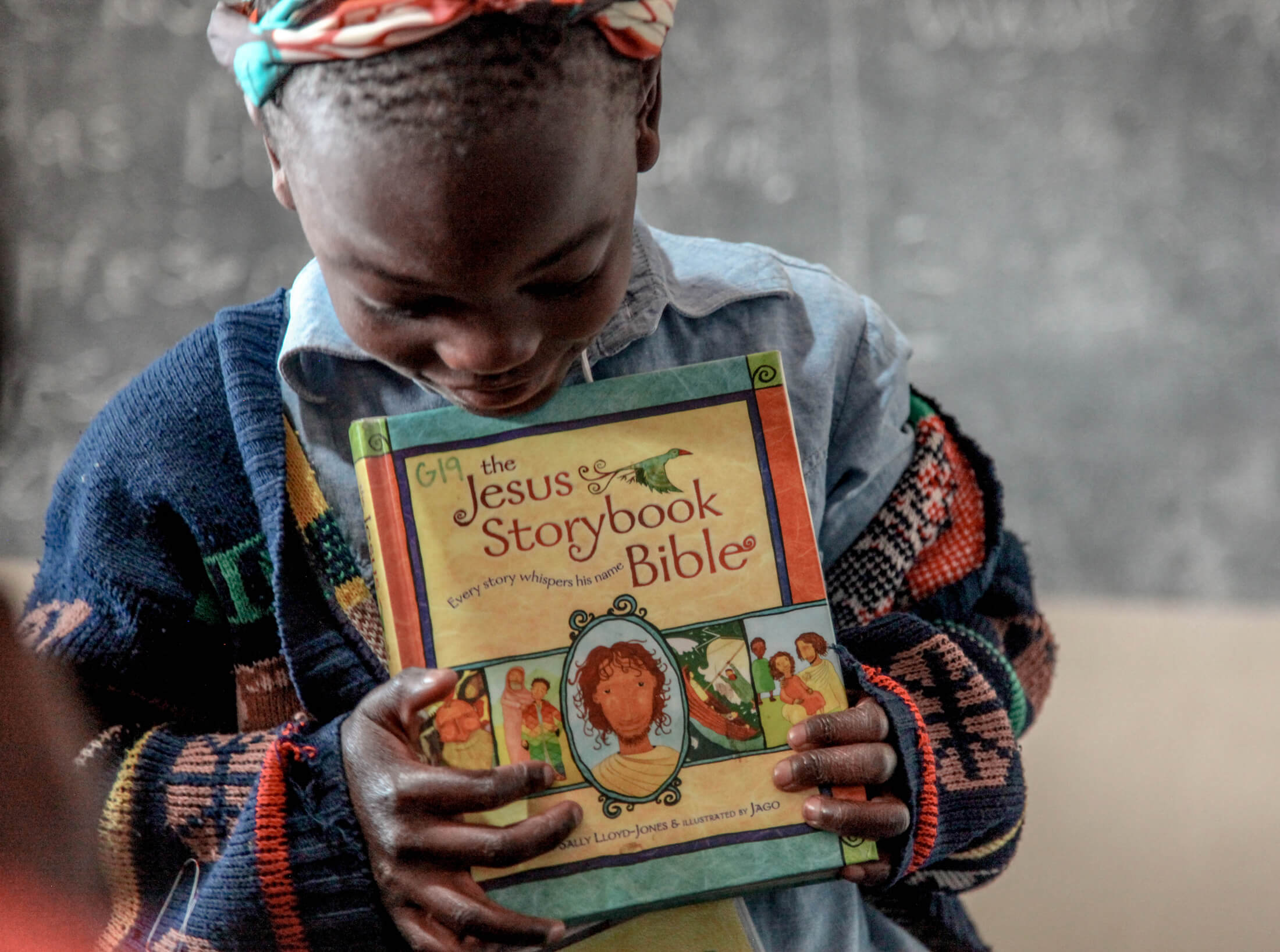 Young student holding a storybook Bible Young student holding a storybook Bible